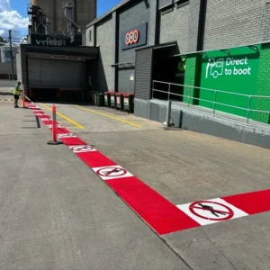 No pedestrian zone safety line marking in red at a commercial loading dock in Central Coast by Iconic Line Marking